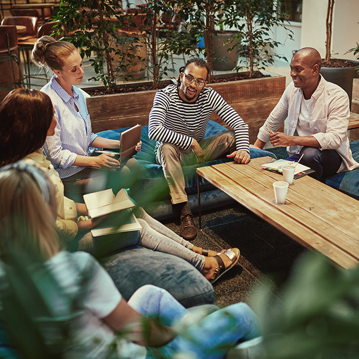 A diverse group of people meeting in a comfortable space.