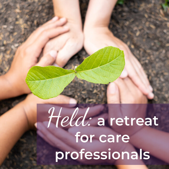 Hands around a sapling with the text, "Held: a retreat for care professionals"
